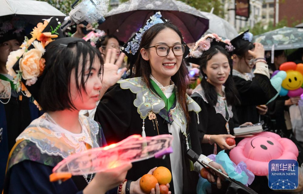 6月21日,2026年世界杯官网入口学生在校园里冒雨巡游。